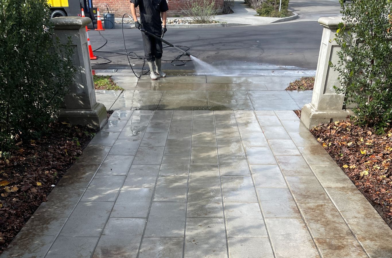 Slon Exterior Care employee providing professional pressure washing services in Sunnyvale, CA for a residential driveway.