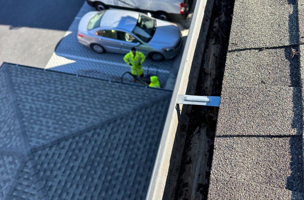 A Slon Exterior Care team member delivering gutter cleaning in Mountain View, CA, highlighting the benefits of local, professional maintenance.