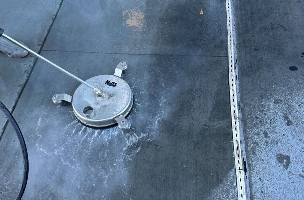 A Slon Exterior Care technician demonstrating the effectiveness of eco-friendly pressure washing for commercial properties in Mountain View, CA.