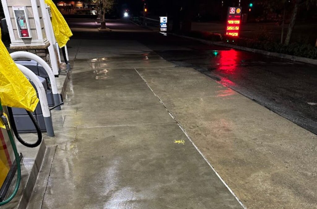 A Slon Exterior Care expert using professional tools to maintain a gas station in San Jose, CA, showcasing top-quality service. Gas Station Cleaning near me.