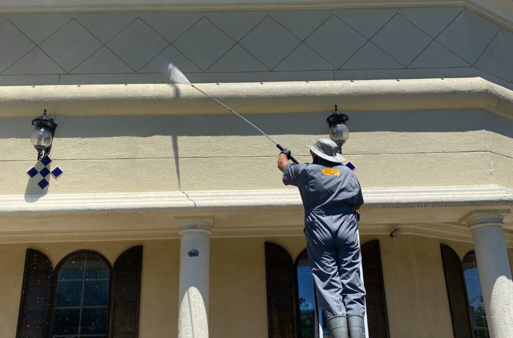 A Slon Exterior Care employee providing expert power washing services in Palo Alto, CA, showcasing professional tools and skills for exterior surfaces.