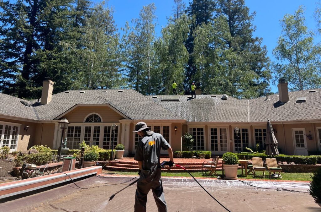A Slon Exterior Care employee power washing a front porch in Santa Clara, CA, using advanced pressure equipment for safe, spotless cleaning results.