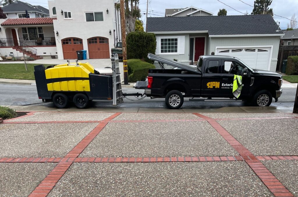 A Slon Exterior Care professional pressure washing a Los Gatos, CA driveway with high-efficiency equipment to ensure spotless results.