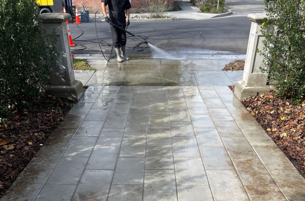 A Slon Exterior Care team member pressure washing a Saratoga, CA property with precision tools and attention to every surface detail.