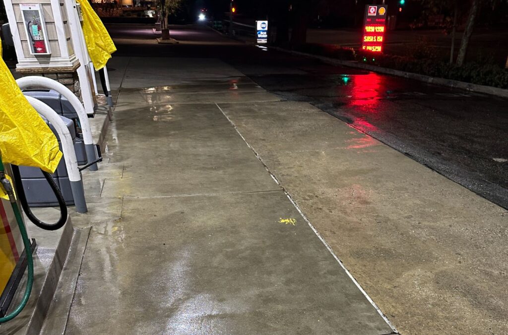 A Slon Exterior Care technician pressure washing in Newark, CA, helping customers understand the benefits of skilled local service. Pressure Washing near me.