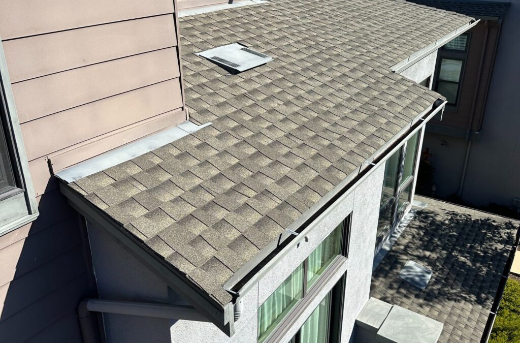 A Slon Exterior Care technician performing gutter cleaning in Los Gatos, CA, emphasizing the long-term advantages of consistent professional service.