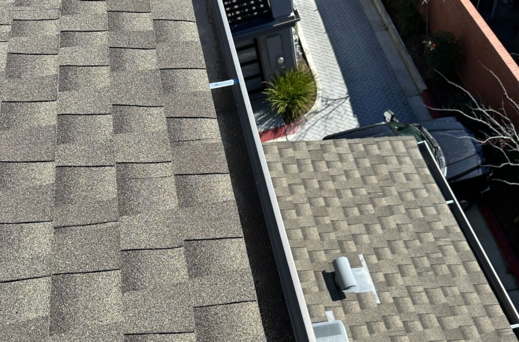 A Slon Exterior Care technician performing gutter cleaning in Campbell, CA, using professional equipment to ensure optimal water flow.