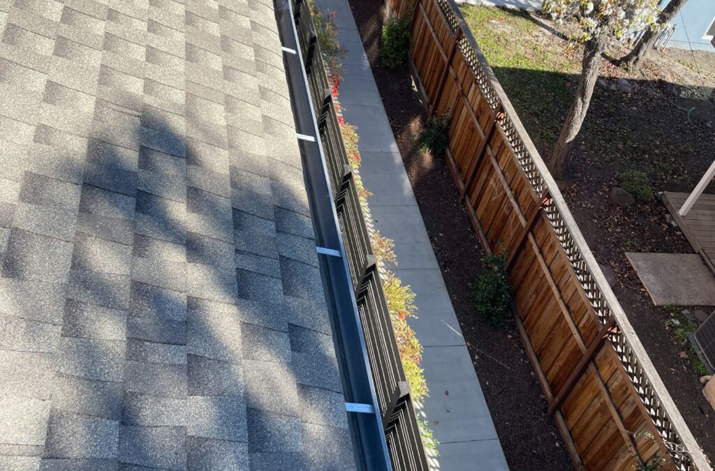 A Slon Exterior Care employee performing gutter cleaning services in Saratoga, CA, using specialized tools to ensure reliable results and home safety.