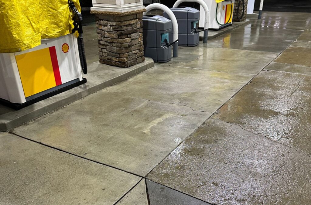 Slon Exterior Care worker cleaning a Los Gatos, CA storefront walkway with precision equipment, highlighting the benefits of local expertise.