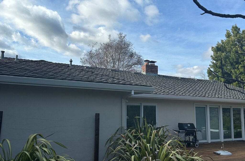 Slon Exterior Care team member performing roof cleaning in Saratoga, CA showing value of regular care and eco protection.