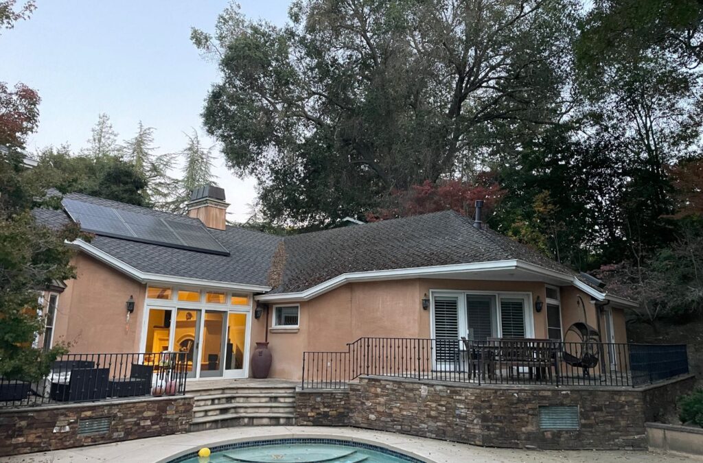 Slon Exterior Care technician performing roof cleaning in Redwood City, CA using eco-safe products for spotless results.