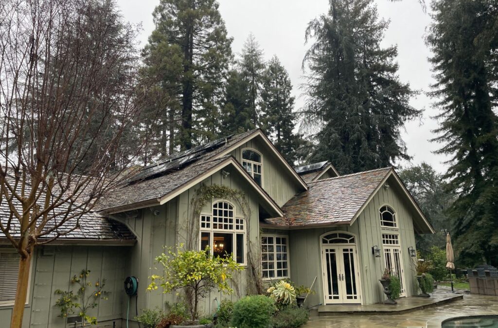 A Slon Exterior Care technician performing roof cleaning in Palo Alto, CA with safe soft-wash methods that restore roofs to like-new condition.