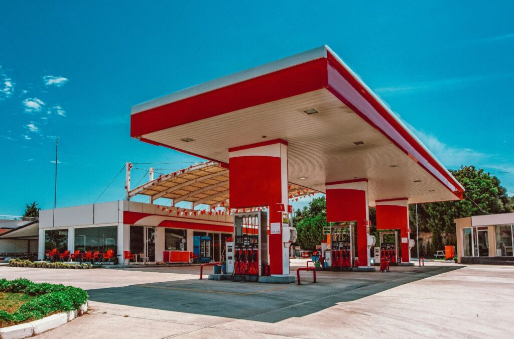 Slon Exterior Care technician performing gas station cleaning in Milpitas, CA using advanced pressure washing tools for deep cleaning